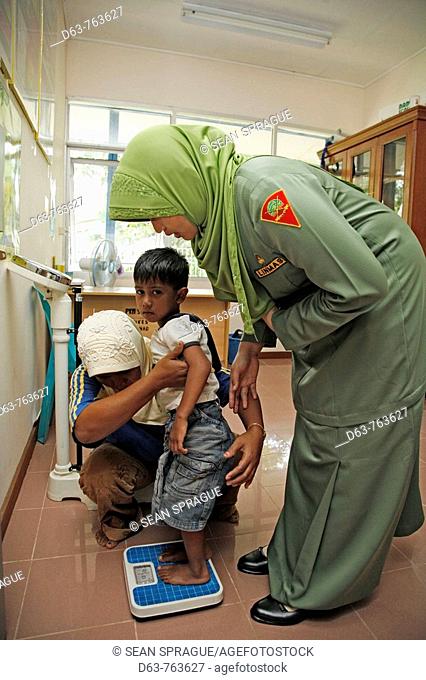 INDONESIA  Government health clinic Pos Kesmas at Cot Seumereng, Desa Pucoh Leung  Weighing a child  Meulaboh, Aceh