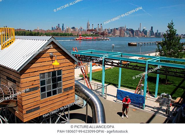 24 May 2018, USA, New York: A play area in the newly built Domino Park in Brooklyn, beside the East River near the Williamsburg Bridge