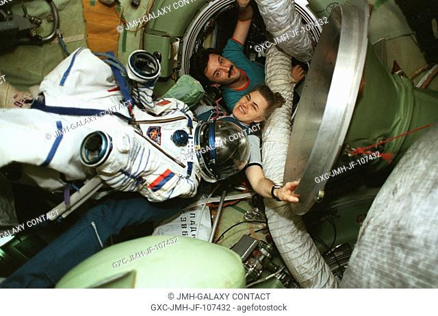 Astronaut Shannon W. Lucid with cosmonaut Aleksandr Y. Kaleri prepare to move Lucid's cosmonaut space suit from Russia's Mir Space Station to the Space Shuttle...