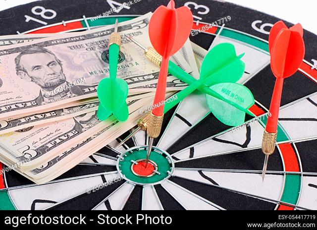 The money on a dartboard background closeup