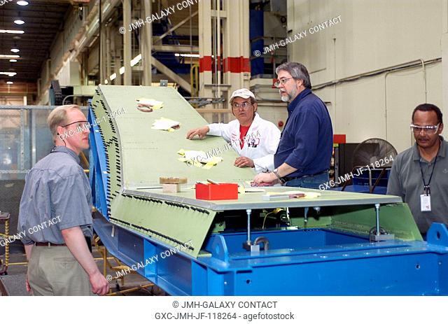 Technicians at the Johnson Space Center in Houston team up to assemble a test article to simulate the inboard leading edge of a Space Shuttle wing as part of...