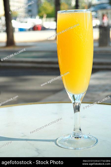 PRODUCTION - 06 October 2023, France, Paris: A Mimosa cocktail stands on the table of a bar. The cocktail made of orange juice and champagne may have been...