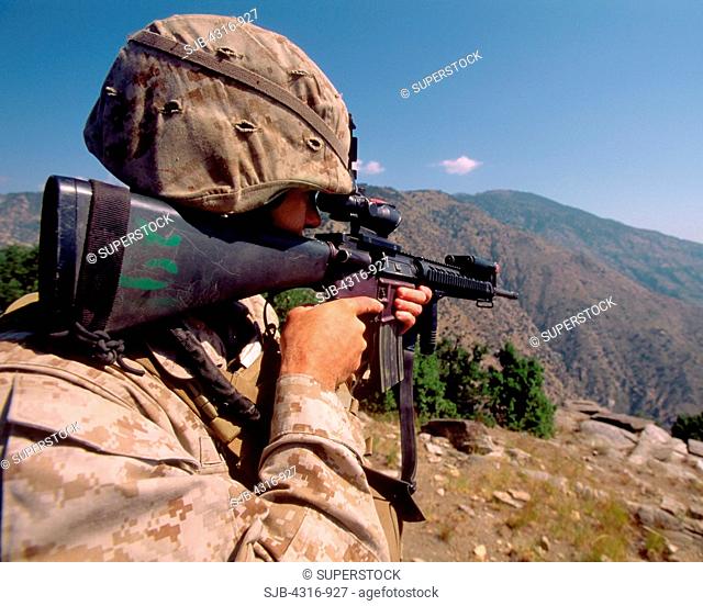 A US Marine Scans the Mountainous Countryside Through the Sights of His M-16