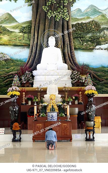 Van Linh buddhist pagoda. Man praying the Buddha. The Enlightenment of the Buddha. An Hao. Vietnam