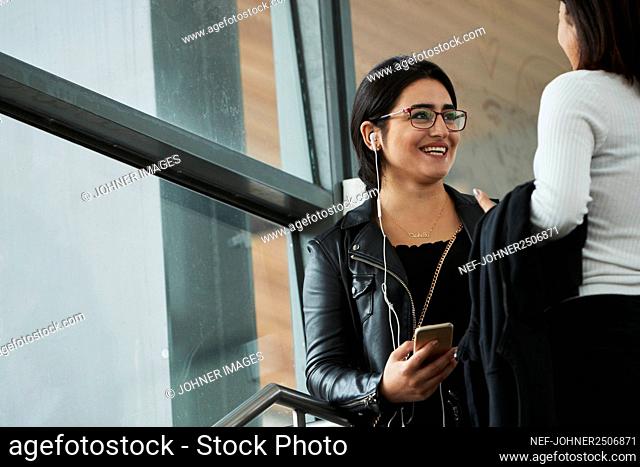 Smiling woman talking to friend