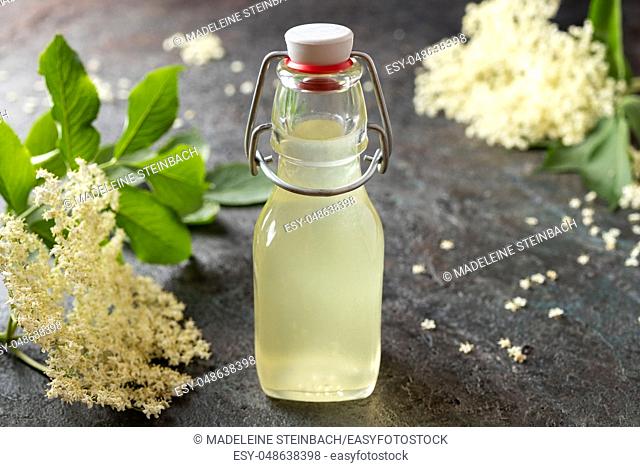 A bottle of homemade herbal syrup made from elder flowers
