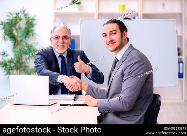 Old and young businessmen in the business meeting concept