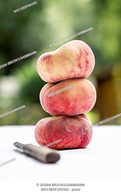 Stacked vineyard peach and knife