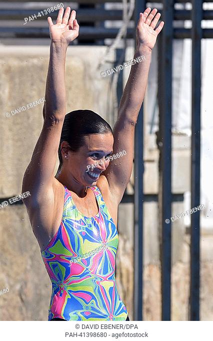 Bronze medalist Anna Bader of Germany celebrates after the women's high diving final of the 15th FINA Swimming World Championships at Moll de la Fusta on the...