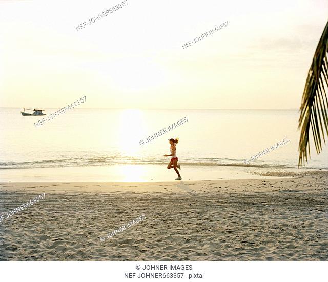 A woman jogging on a beach