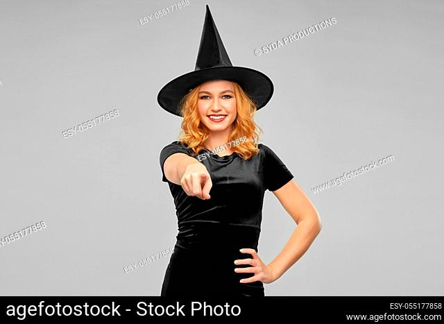 woman in costume of witch pointing to camera
