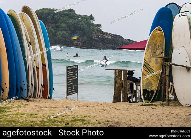 Hiriketiya Beach, Sri Lanka Tourists surfing under a Ukrainian flag