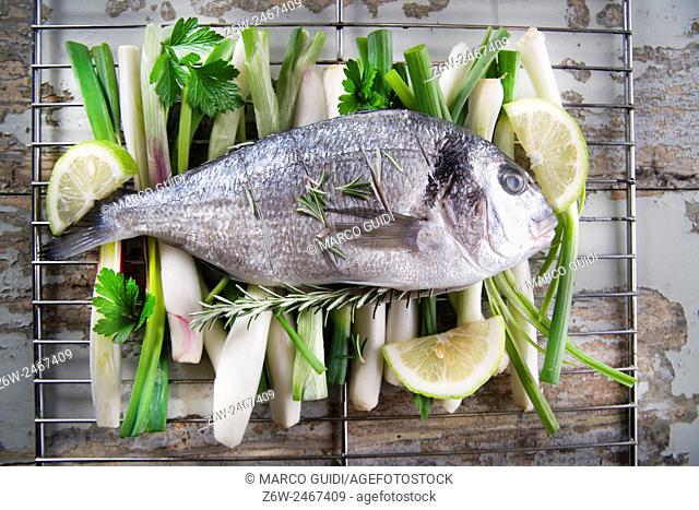 Presentation and preparation of a second dish of sea bream and onions