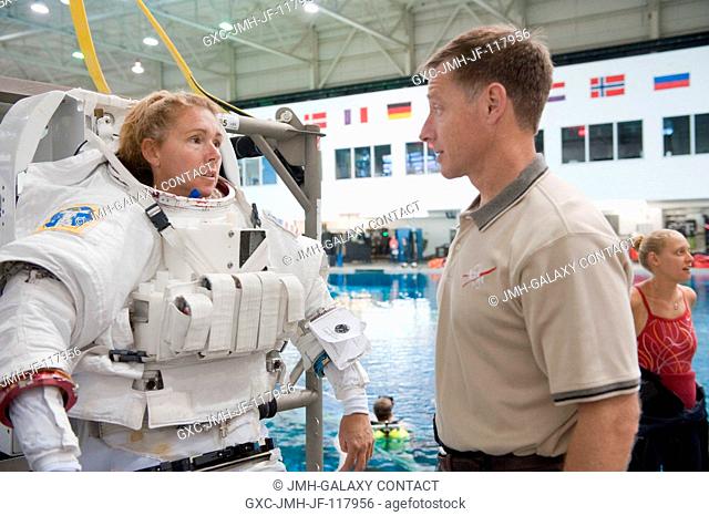 NASA astronaut Sandy Magnus, STS-135 mission specialist, attired in a training version of her Extravehicular Mobility Unit (EMU) spacesuit