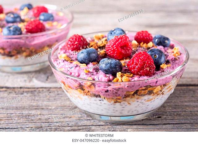 Chia yogurt with granola and berries ( blueberries , raspberry )
