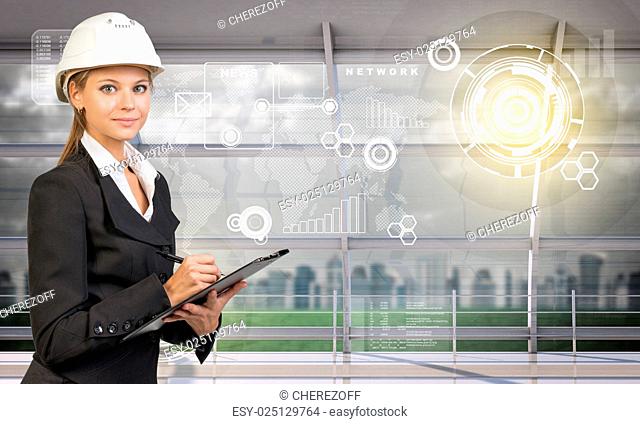 Young woman holding folder in hard hat