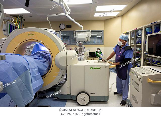 Englewood, Colorado - A CT scan machine, the Stealth O-arm spinal navigation, is used to obtain imaging before a surgical team performs minimally invasive...
