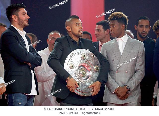 MUNICH, GERMANY - MAY 14: Arturo Vidal holds The Meisterschale, the trophy of the German football championship next too David Alaba during the FC Bayern...
