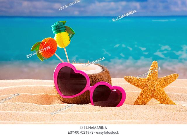Coconut cocktail on tropical white sand beach heart shape funny sunglasses