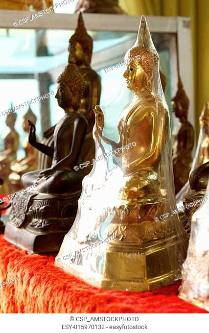 Buddha statues in plastic wrap