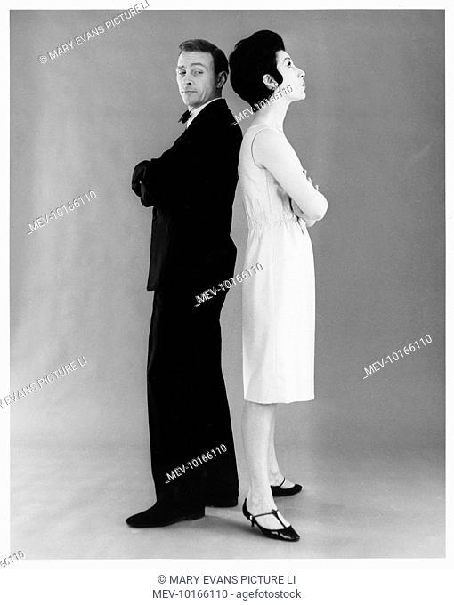A couple in formal evening dress pose for the camera