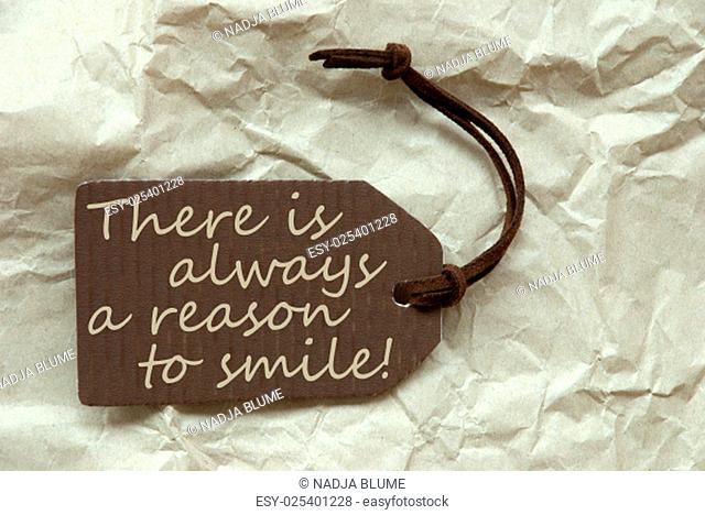 One Brown Label Or Tag With Brown Ribbon On Crumpled Paper Background. With English Life Quote There Is Always A Reason To Smile Vintage Or Retro Style