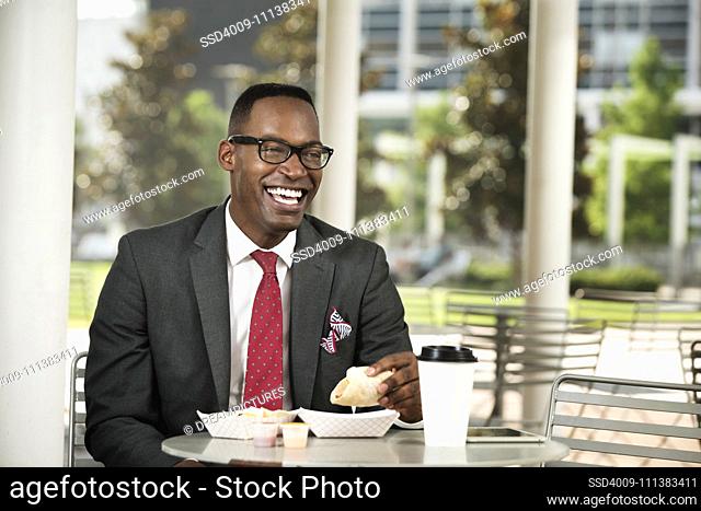 Black businessman eating at cafe