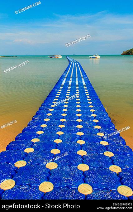 Beautiful blue pontoon made from plastic floating in the sea, rotomolding jetty, a landing stage or small pier at which boats can dock or be moored