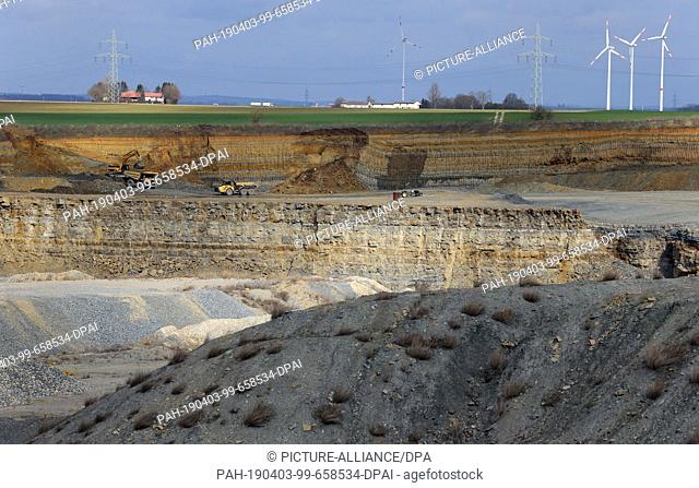 26 March 2019, Bavaria, Aub: The quarry of a gravel plant lies in the Franconian landscape. Waste and chemicals are said to have been disposed of illegally in...
