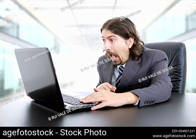 surprised businessman working with is laptop at the office