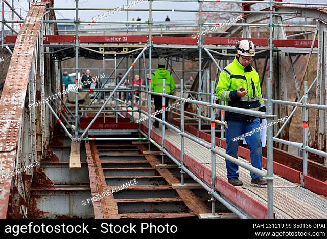 19 December 2023, Saxony-Anhalt, Weddersleben: Employees of an engineering firm prepare to move the Peace Bridge in Weddersleben