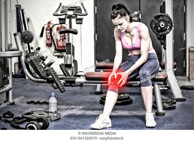 Composite image of healthy woman with an injured knee sitting in gym