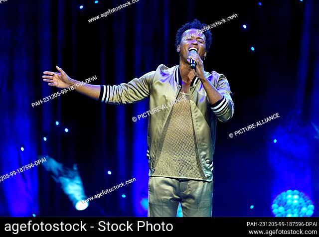 05 December 2023, Hamburg: Musical actor Benet Monteiro as Hercules sings during the press presentation of Disney's musical ""Hercules"" on stage at the...