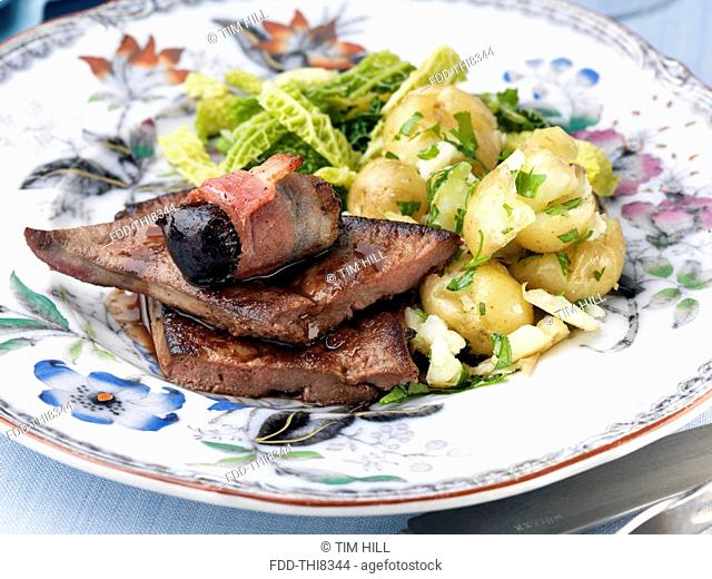 Calves liver with devils on horseback cabbage and potatoes
