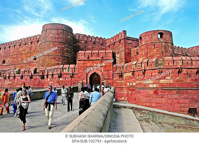 Old historical monument Red Agra Fort Agra Uttar Pradesh India ancient blue sky castle citadel clouds Color entrance exterior famous fort Fort fortification...