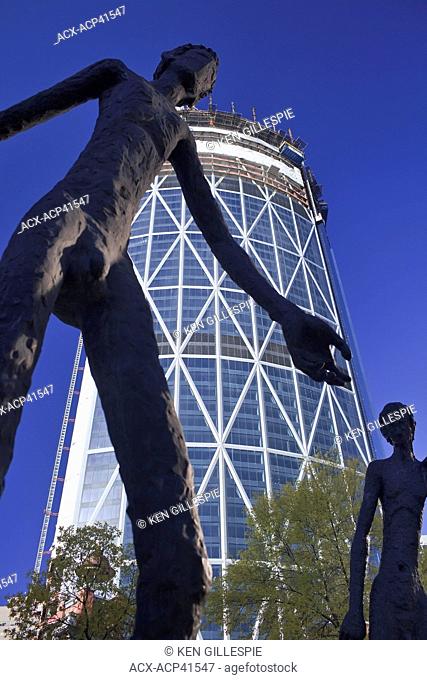 Family of Man sculpture, and The Bow office tower under construction. Calgary, Alberta, Canada