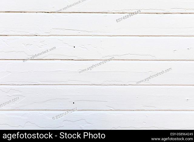 Old planks on house wall with new paint. The old paint makes texture in the new paint