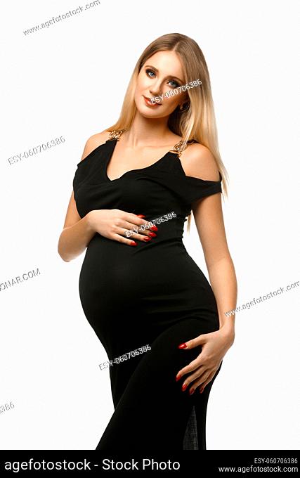 Beautiful pregnant young woman in long black dress. Studio portrait isolated on white background. Copy space