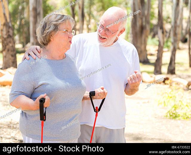 Happy healthy senior couple exercising outside together