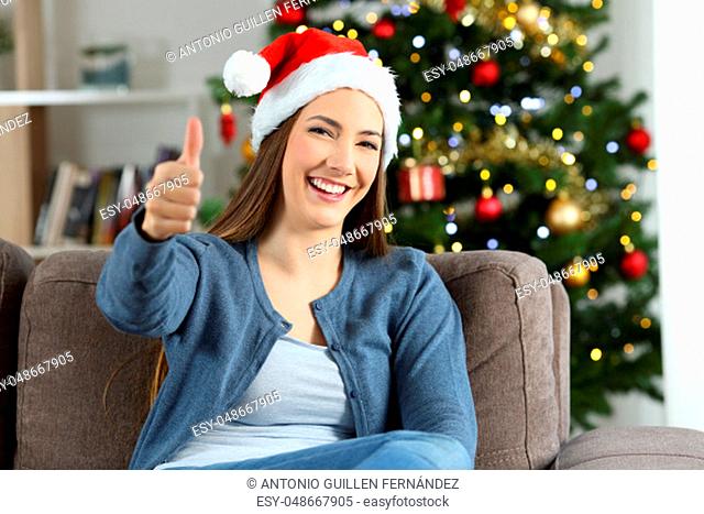 Girl with thumbs up posing on chritmas at home