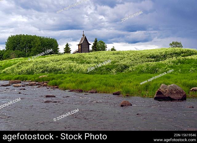 Wooden chapel on the banks of the river Keret. At this point the Keret River flows into the White Sea. Karelia, Russia, end of June