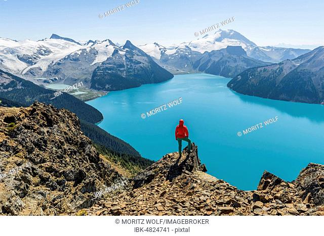 View from Panorama Ridge Hiking Trail, Hiker on a Rock, Garibaldi Lake, Guard Mountain and Deception Peak, Back Glacier, Garibaldi Provincial Park