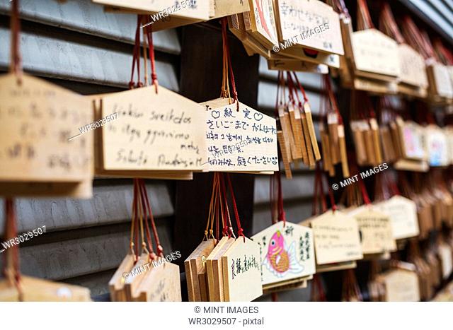 Close up of wooden ema or prayer plaques at a Japanese Shinto Shrine