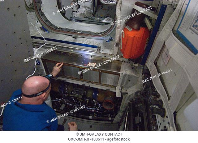 European Space Agency astronaut Andre Kuipers, Expedition 30 flight engineer, performs the scheduled inspection and extensive cleanup of ventilation systems in...