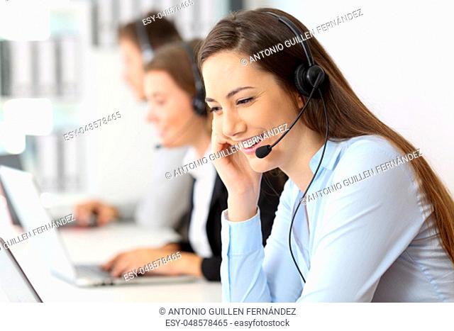 Telemarketing operator talking working at office with other workers in the background