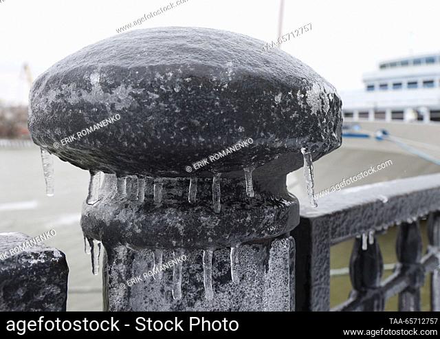 RUSSIA, ROSTOV-ON-DON - DECEMBER 13, 2023: Glaze ice from freezing rain covers the waterfront railing. Strong winds with gusts of up to 18 metres per second and...