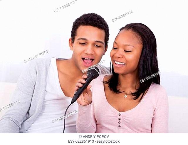 Couple Singing With Microphone