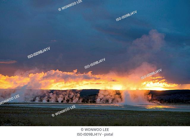 Landscape with steaming geysers at sunset, Yellowstone National Park, Wyoming, USA