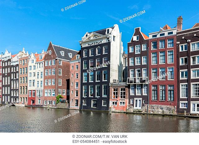 Cityscape of Amsterdam city with historic houses along Canals
