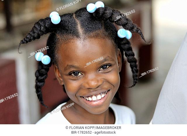Portrait of a smiling girl with funny hairstyle, Delmas 89 district, Port-au-Prince, Haiti, Caribbean, Central America